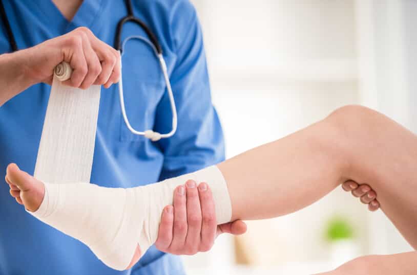 Medical Professional Wrapping Injured Leg